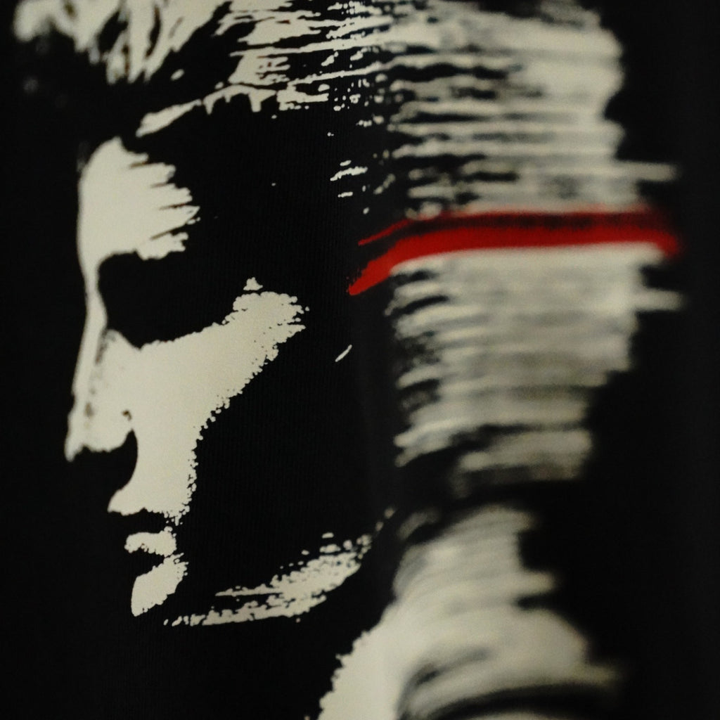 STRATUM HEAD back print detail — profile dissolving into strata with red line through the eyes