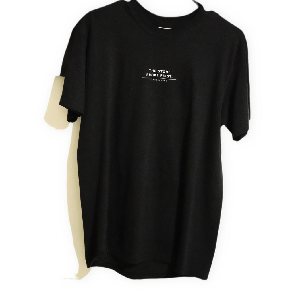 GREW ANYWAY tee front — THE STONE BROKE FIRST phrase set small across the chest