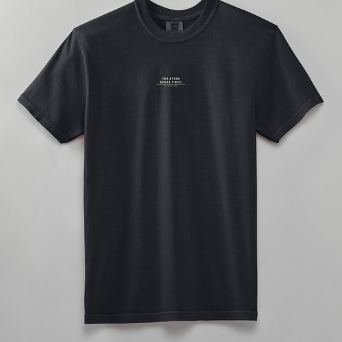 GREW ANYWAY heavyweight tee in black, front, THE STONE BROKE FIRST phrase on the chest