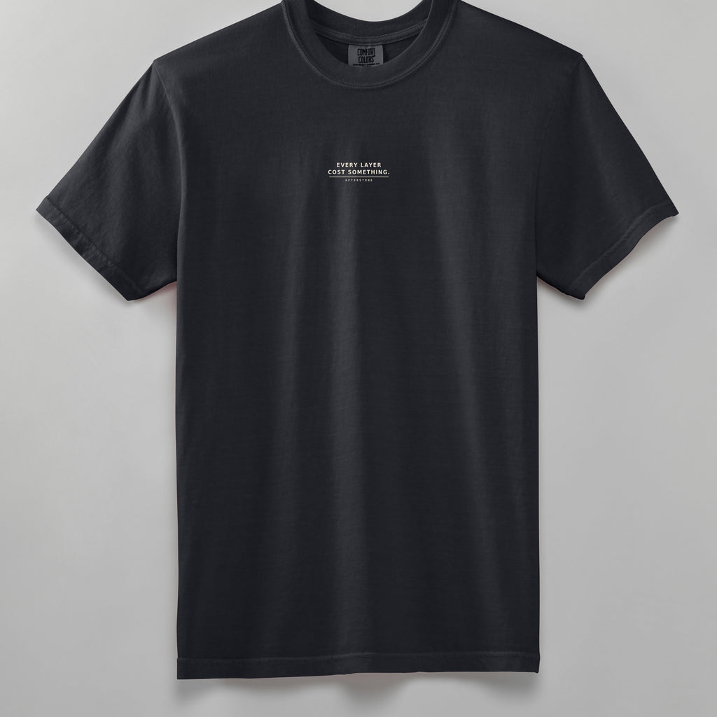 STRATUM HEAD heavyweight tee in black, front, EVERY LAYER COST SOMETHING phrase on the chest